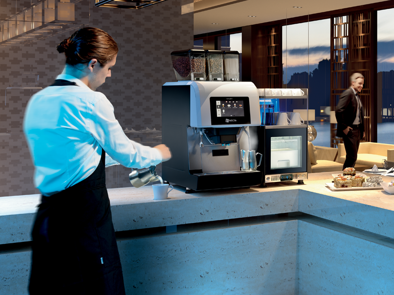 Worker brewing a freshly brewed coffee at the ConviStore Micro Market, featuring the sleek Evoca Kalea Plus coffee machine.